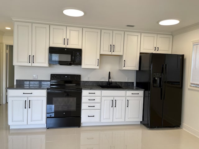 1225 NW 21st St NW Unit 15-1505, Stuart, FL 34994 - kitchen featuring black appliances, a sink, white cabinetry, crown molding, and dark stone countertops