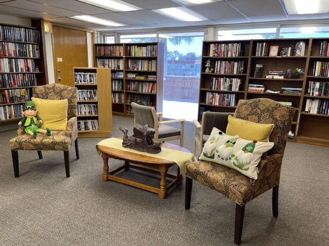 1225 NW 21st St NW Unit 15-1505, Stuart, FL 34994 - sitting room featuring wall of books and carpet