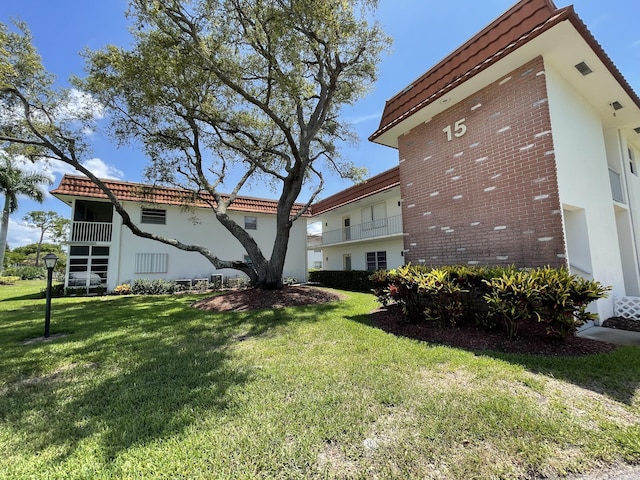 1225 NW 21st St NW Unit 15-1505, Stuart, FL 34994 - view of side of property with a lawn and brick siding