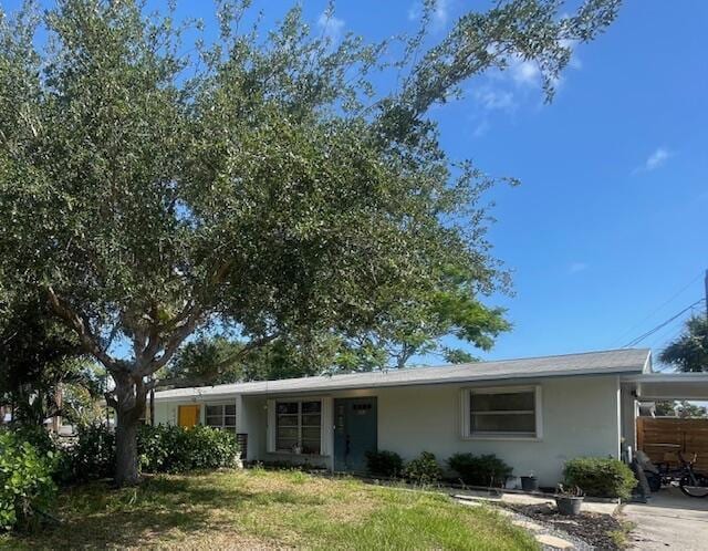 503 SE Robalo Ct, Stuart, FL 34996 - single story home featuring a carport, stucco siding, and driveway