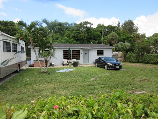 773 Arlington Dr, West Palm Beach, FL 33415 - ranch-style house with a front lawn