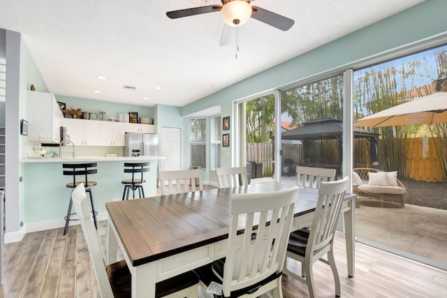 7989 Lakewood Cove Ct, Lake Worth, FL 33467 - dining room featuring light wood-style floors, ceiling fan, and recessed lighting