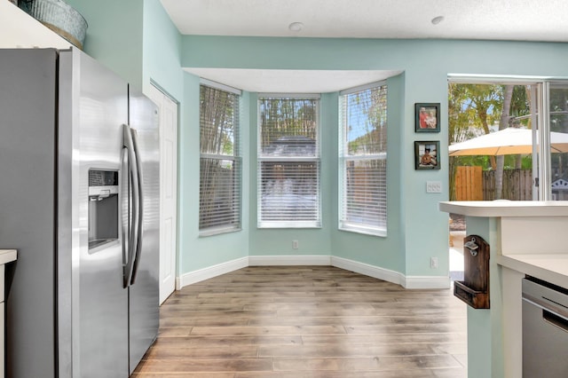 7989 Lakewood Cove Ct, Lake Worth, FL 33467 - kitchen with appliances with stainless steel finishes, wood finished floors, baseboards, and light countertops