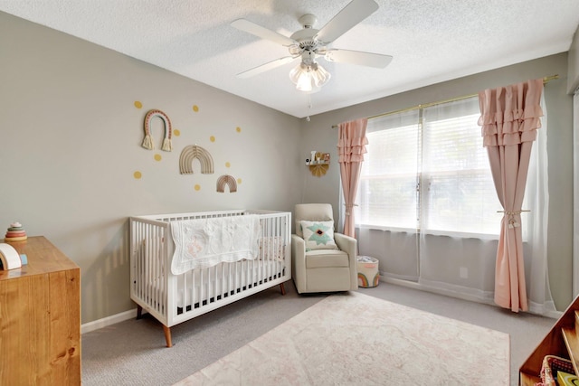 7989 Lakewood Cove Ct, Lake Worth, FL 33467 - bedroom with carpet flooring, a crib, a textured ceiling, a ceiling fan, and baseboards