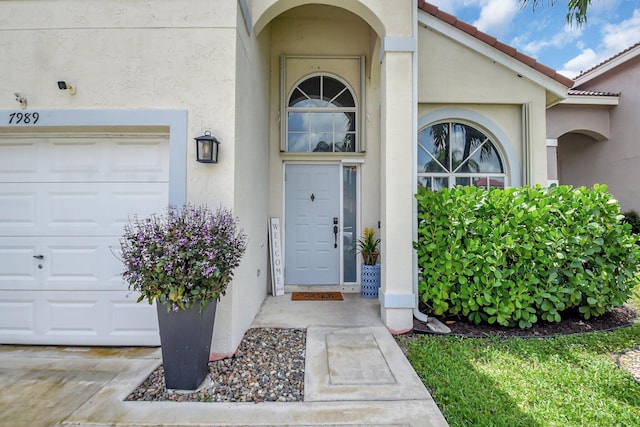 7989 Lakewood Cove Ct, Lake Worth, FL 33467 - doorway to property with stucco siding