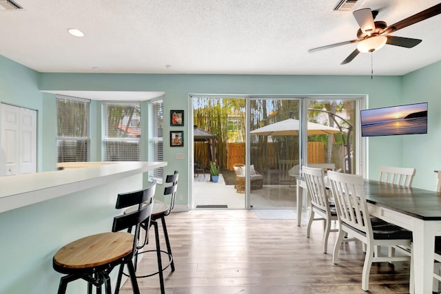 7989 Lakewood Cove Ct, Lake Worth, FL 33467 - dining space featuring wood finished floors, ceiling fan, recessed lighting, and a textured ceiling
