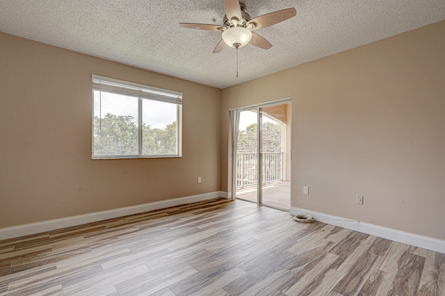 3870 Lyons Rd Unit 308-8, Coconut Creek, FL 33073 - unfurnished room with a textured ceiling, ceiling fan, light wood-style flooring, and baseboards