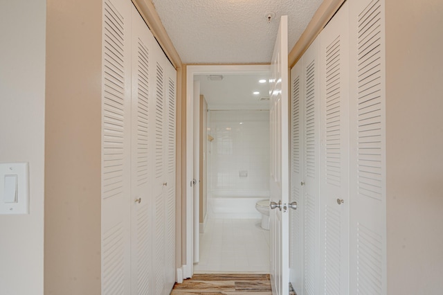 3870 Lyons Rd Unit 308-8, Coconut Creek, FL 33073 - hallway featuring a textured ceiling