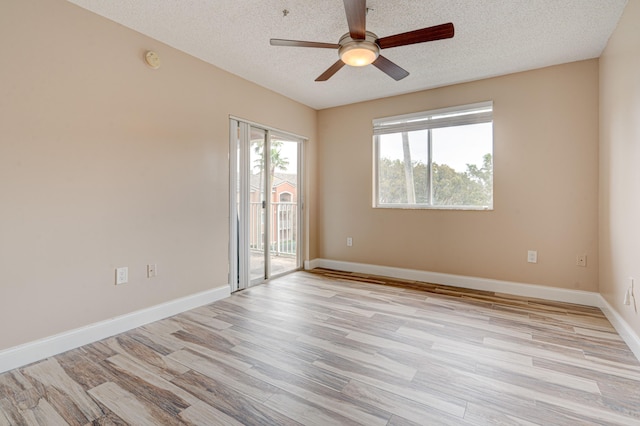 3870 Lyons Rd Unit 308-8, Coconut Creek, FL 33073 - spare room featuring light wood-style floors, a ceiling fan, a textured ceiling, baseboards, and a smoke detector