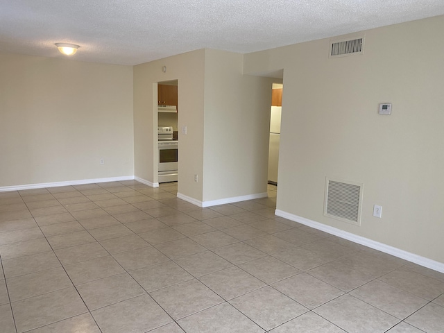 405 W Executive Center Dr Unit 208, West Palm Beach, FL 33401 - unfurnished room with a textured ceiling, light tile patterned flooring, and baseboards