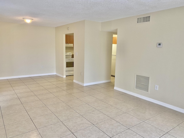 405 W Executive Center Dr Unit 208, West Palm Beach, FL 33401 - unfurnished room with a textured ceiling, light tile patterned flooring, and baseboards