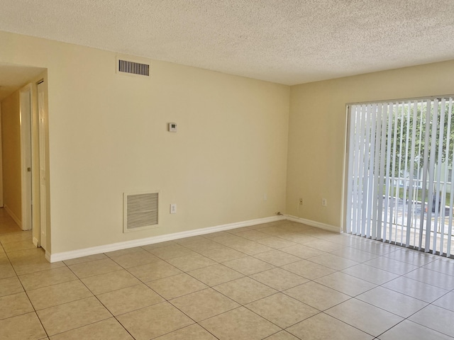 405 W Executive Center Dr Unit 208, West Palm Beach, FL 33401 - empty room with light tile patterned floors, a textured ceiling, and baseboards