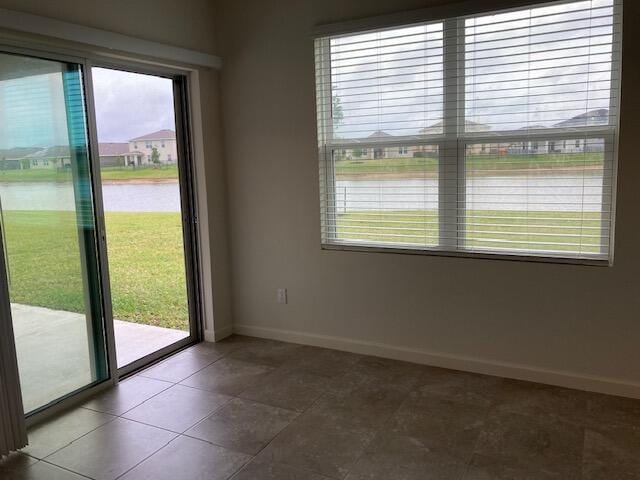 10789 SW Cremona Way, Port Saint Lucie, FL 34987 - spare room with baseboards and a water view