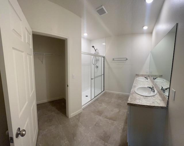 10789 SW Cremona Way, Port Saint Lucie, FL 34987 - full bathroom featuring a stall shower, double vanity, a walk in closet, recessed lighting, and tile patterned flooring