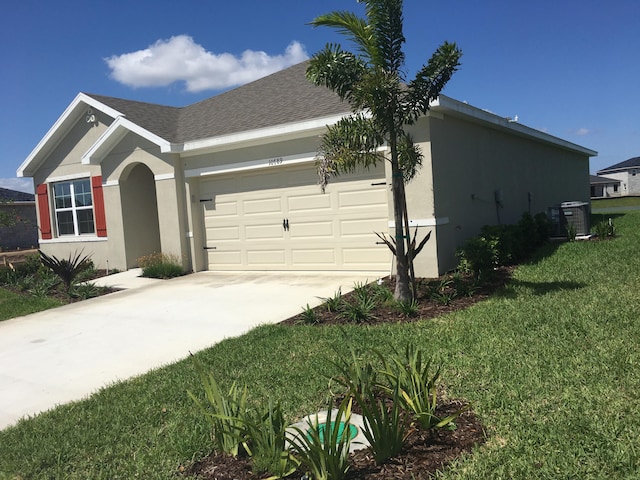 10789 SW Cremona Way, Port Saint Lucie, FL 34987 - view of front facade featuring driveway, a front yard, an attached garage, stucco siding, and a shingled roof