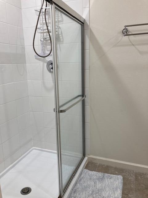10789 SW Cremona Way, Port Saint Lucie, FL 34987 - full bathroom featuring a shower stall and baseboards