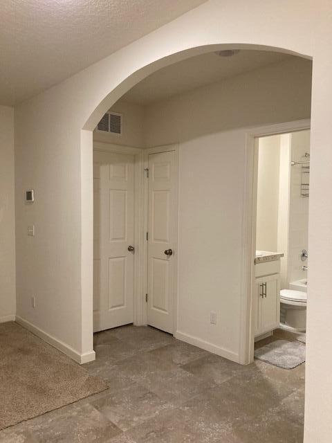 10789 SW Cremona Way, Port Saint Lucie, FL 34987 - hallway with arched walkways and baseboards