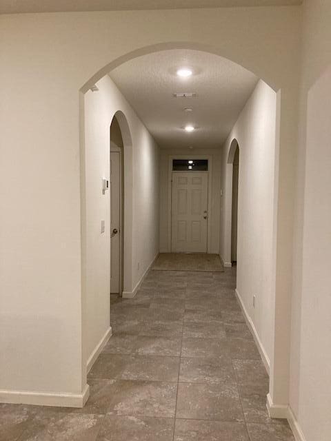 10789 SW Cremona Way, Port Saint Lucie, FL 34987 - hallway with baseboards and arched walkways