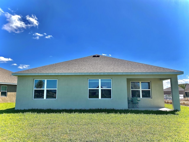 10789 SW Cremona Way, Port Saint Lucie, FL 34987 - view of property exterior featuring roof with shingles, stucco siding, and a lawn
