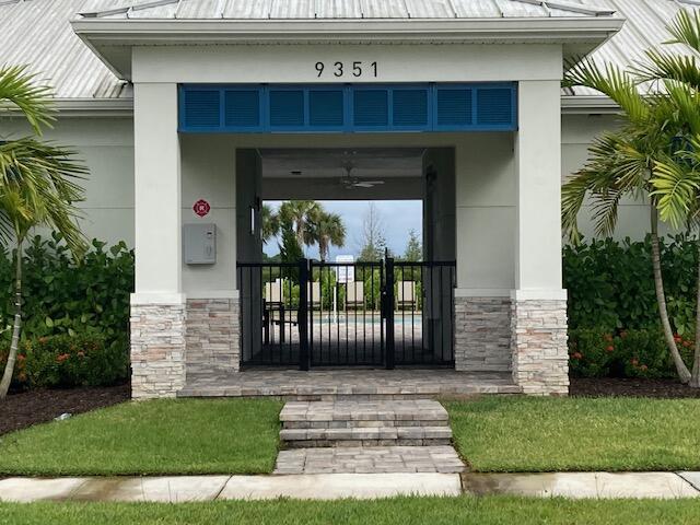 10789 SW Cremona Way, Port Saint Lucie, FL 34987 - entrance to property featuring a standing seam roof, a metal roof, stone siding, and stucco siding