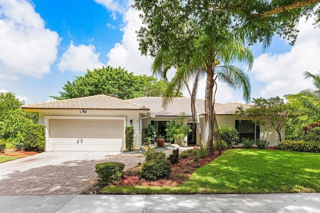 3523 Pine Haven Cir, Boca Raton, FL 33431 - view of front of home featuring a tile roof, driveway, a garage, stucco siding, and a front lawn