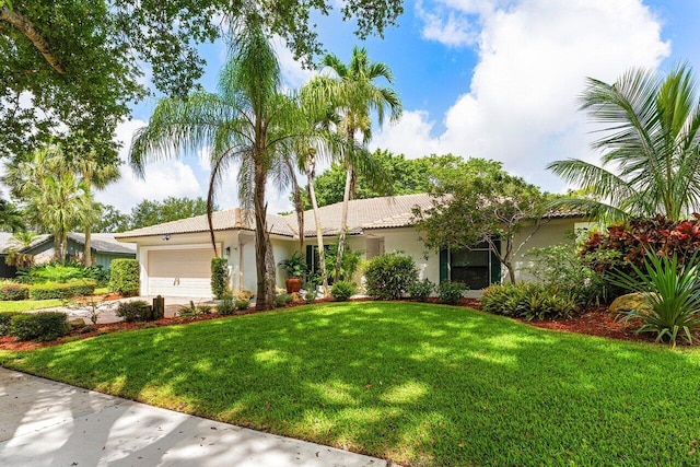3523 Pine Haven Cir, Boca Raton, FL 33431 - view of front of house featuring stucco siding, a garage, a front lawn, and concrete driveway