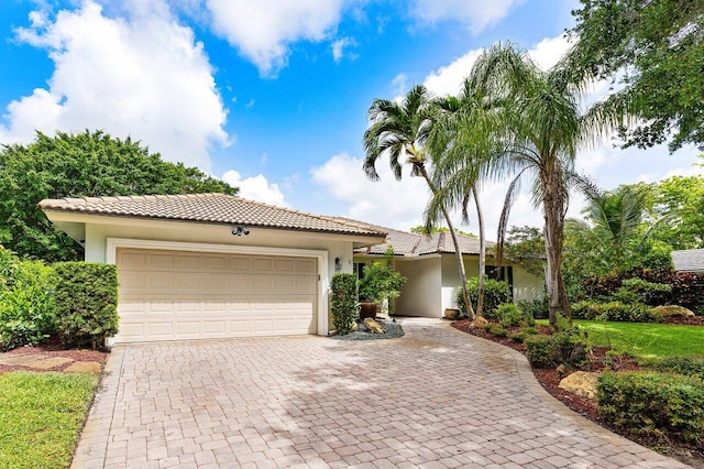 3523 Pine Haven Cir, Boca Raton, FL 33431 - view of front of home featuring a tiled roof, stucco siding, a garage, and decorative driveway