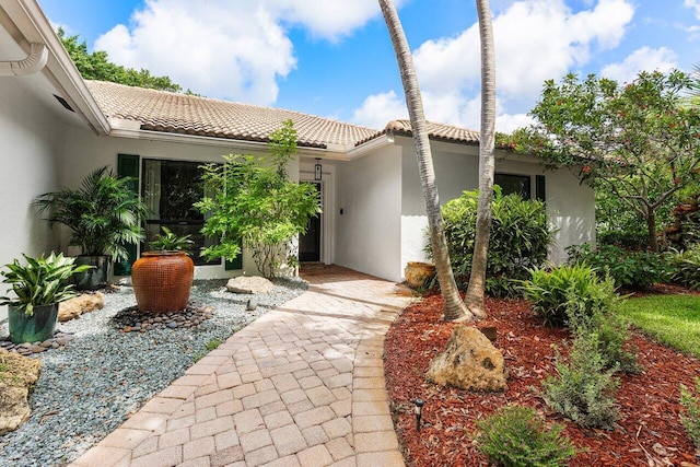 3523 Pine Haven Cir, Boca Raton, FL 33431 - view of exterior entry with stucco siding and a tile roof