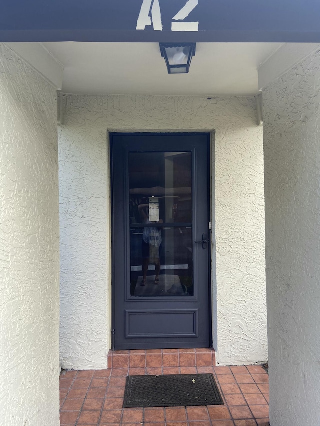 6004 Indrio Rd Unit 2, Fort Pierce, FL 34951 - doorway to property with stucco siding