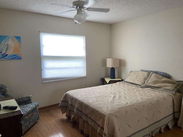 6004 Indrio Rd Unit 2, Fort Pierce, FL 34951 - bedroom featuring hardwood / wood-style flooring, a textured ceiling, and a ceiling fan