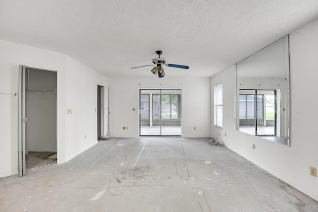 654 SW Kayak Ave, Port Saint Lucie, FL 34953 - unfurnished bedroom featuring access to outside, a textured ceiling, ceiling fan, and a spacious closet