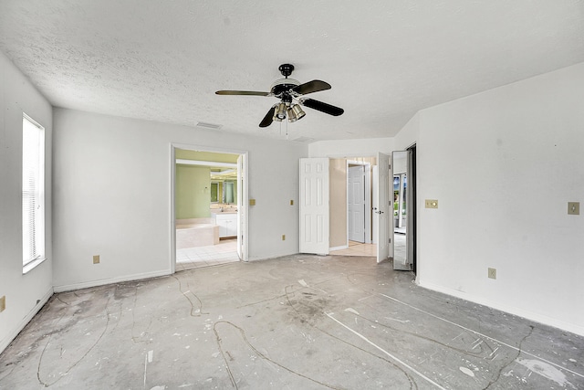 654 SW Kayak Ave, Port Saint Lucie, FL 34953 - unfurnished bedroom featuring baseboards, ensuite bath, and ceiling fan