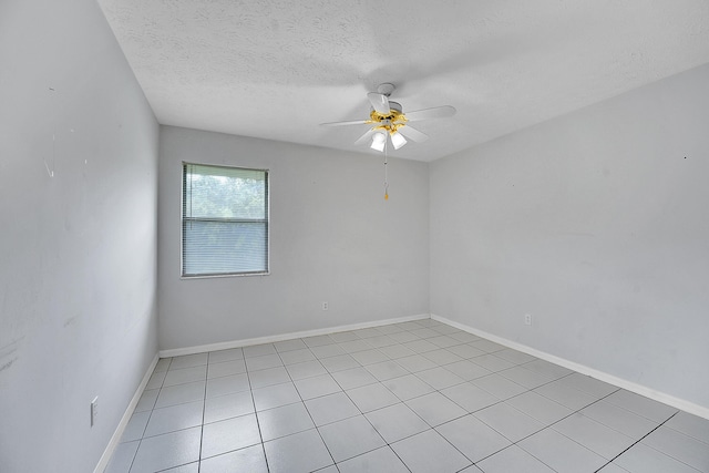 654 SW Kayak Ave, Port Saint Lucie, FL 34953 - unfurnished room with ceiling fan, a textured ceiling, light tile patterned floors, and baseboards