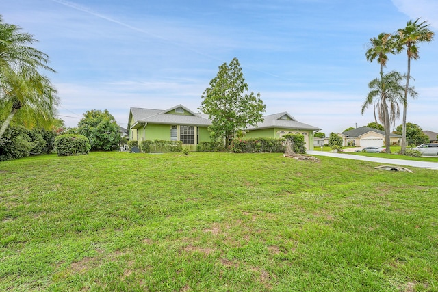 654 SW Kayak Ave, Port Saint Lucie, FL 34953 - view of front of property featuring concrete driveway, a front yard, and stucco siding