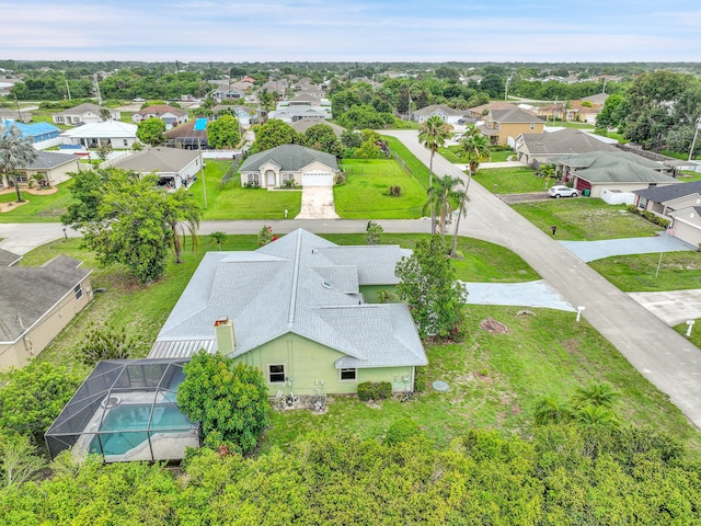 654 SW Kayak Ave, Port Saint Lucie, FL 34953 - aerial perspective of suburban area featuring a pool area
