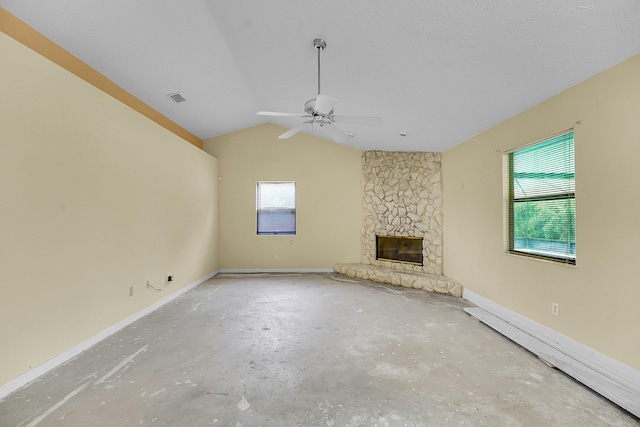 654 SW Kayak Ave, Port Saint Lucie, FL 34953 - unfurnished living room featuring plenty of natural light, a fireplace, unfinished concrete flooring, lofted ceiling, and a ceiling fan