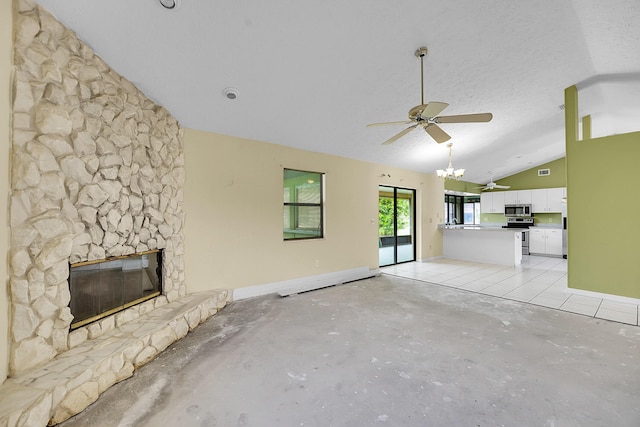 654 SW Kayak Ave, Port Saint Lucie, FL 34953 - unfurnished living room with lofted ceiling, a fireplace, a ceiling fan, concrete floors, and a chandelier