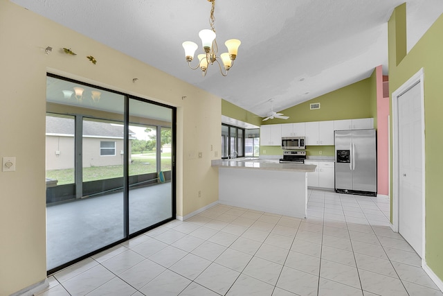 654 SW Kayak Ave, Port Saint Lucie, FL 34953 - kitchen featuring stainless steel appliances, lofted ceiling, a peninsula, a chandelier, and light countertops