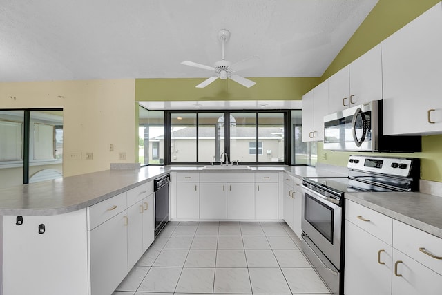 654 SW Kayak Ave, Port Saint Lucie, FL 34953 - kitchen with appliances with stainless steel finishes, a sink, a peninsula, a ceiling fan, and plenty of natural light