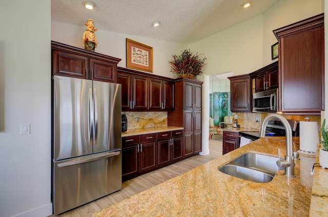 4290 Camrose Ln, West Palm Beach, FL 33417 - kitchen with stainless steel appliances, decorative backsplash, light wood-style flooring, light stone counters, and recessed lighting