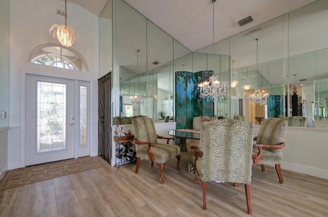 4290 Camrose Ln, West Palm Beach, FL 33417 - dining space with a chandelier, wood finished floors, and a high ceiling