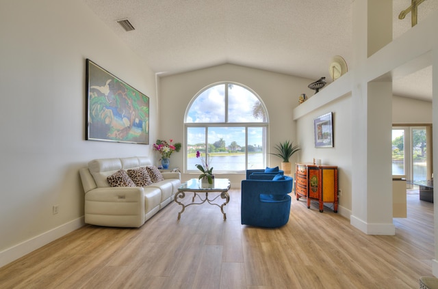 4290 Camrose Ln, West Palm Beach, FL 33417 - living area with light wood finished floors, lofted ceiling, a textured ceiling, and a water view
