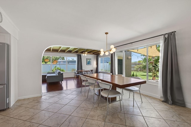 2476 S Florida Mango Rd, West Palm Beach, FL 33406 - dining area featuring a chandelier, light tile patterned floors, and baseboards