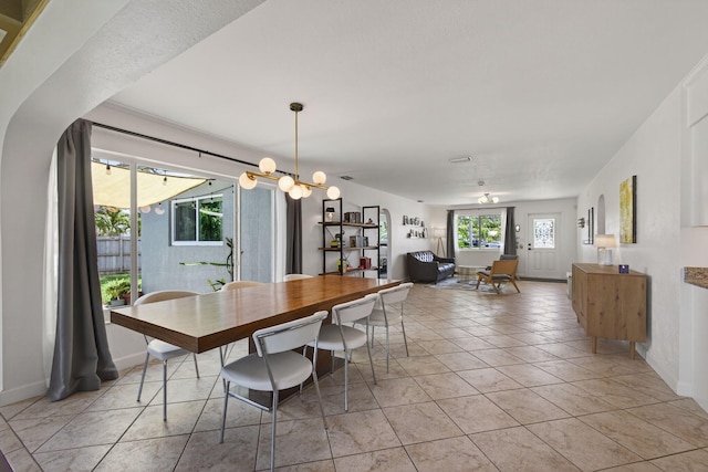 2476 S Florida Mango Rd, West Palm Beach, FL 33406 - dining area with baseboards, light tile patterned flooring, and a chandelier