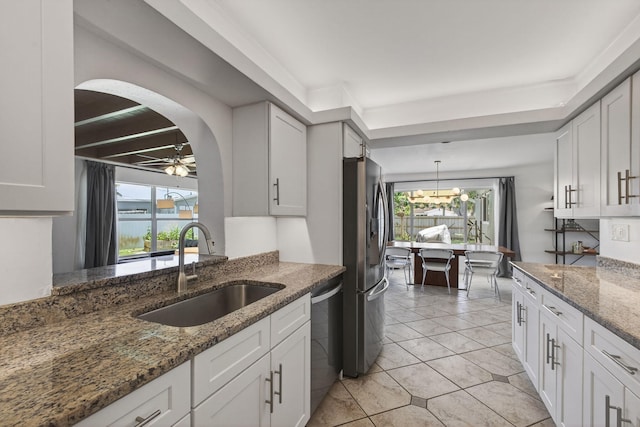2476 S Florida Mango Rd, West Palm Beach, FL 33406 - kitchen with a sink, stainless steel appliances, arched walkways, and white cabinetry