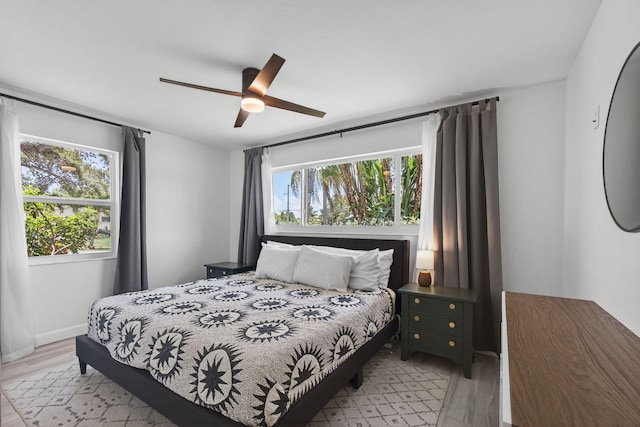 2476 S Florida Mango Rd, West Palm Beach, FL 33406 - bedroom with multiple windows, light wood-style flooring, ceiling fan, and baseboards