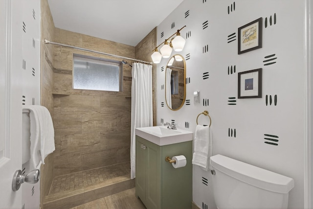 2476 S Florida Mango Rd, West Palm Beach, FL 33406 - full bathroom with toilet, vanity, a tile shower, and wood finished floors