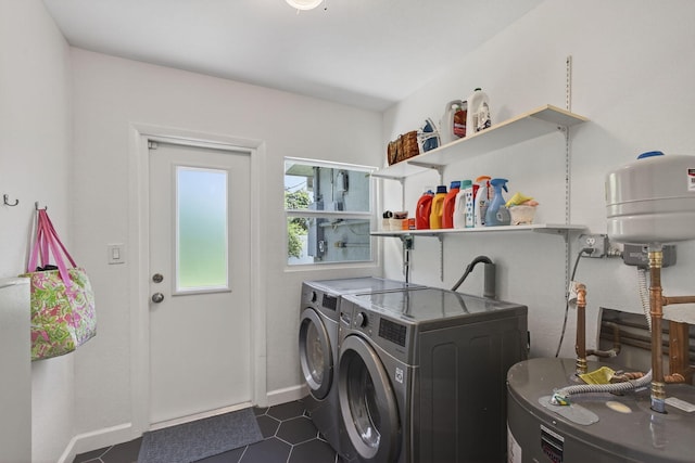 2476 S Florida Mango Rd, West Palm Beach, FL 33406 - laundry room featuring water heater, washing machine and dryer, baseboards, and dark tile patterned floors