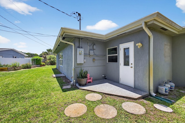 2476 S Florida Mango Rd, West Palm Beach, FL 33406 - back of property with stucco siding and a patio area