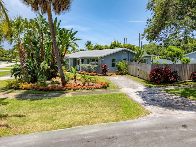 2476 S Florida Mango Rd, West Palm Beach, FL 33406 - view of front of property featuring asphalt driveway and stucco siding